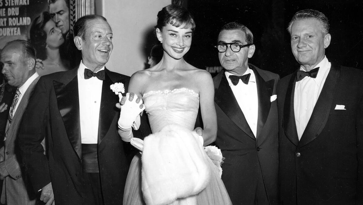 AP Photo. Photographed with songwriter Cole Porter, composer Irving Berlin and producer Don Hartman.